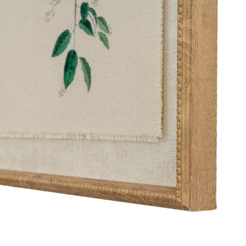 Framed artwork with green leaves on a beige background