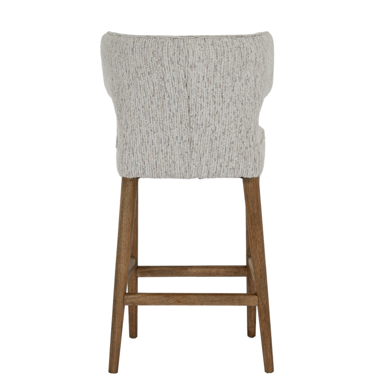 Bar stool with gray cushioned seat and wooden legs on a white background