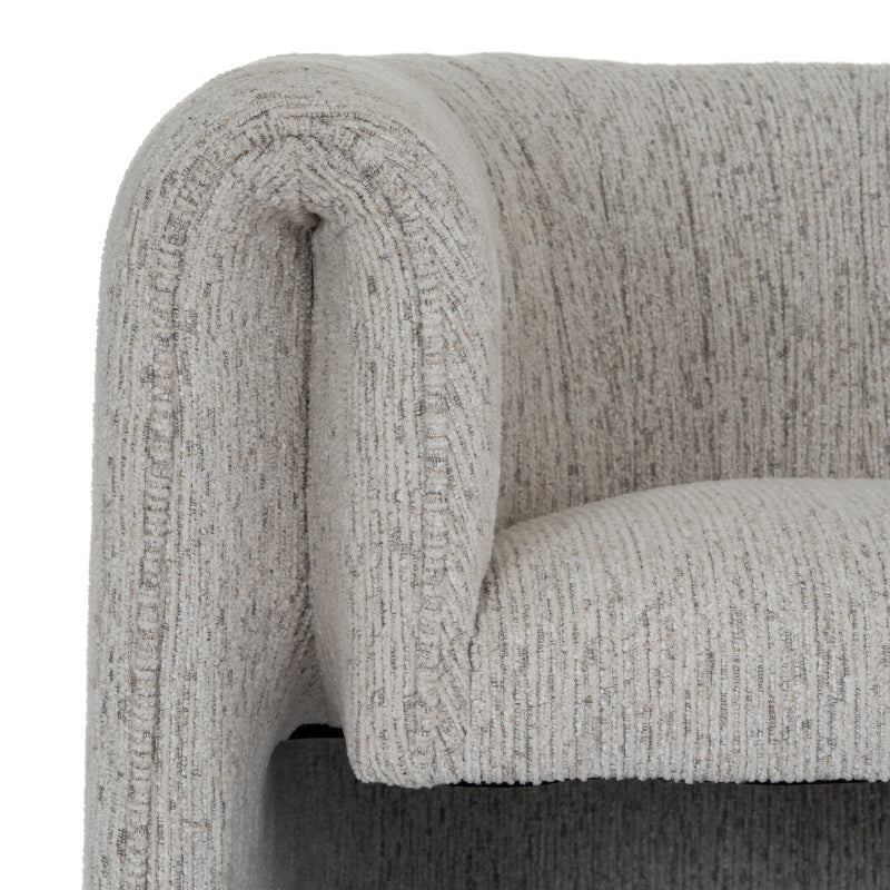 Close-up of a textured grey armchair armrest