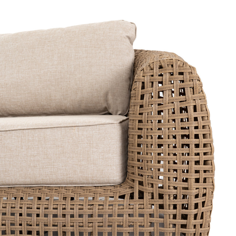 Wicker chair with beige cushions on a white background