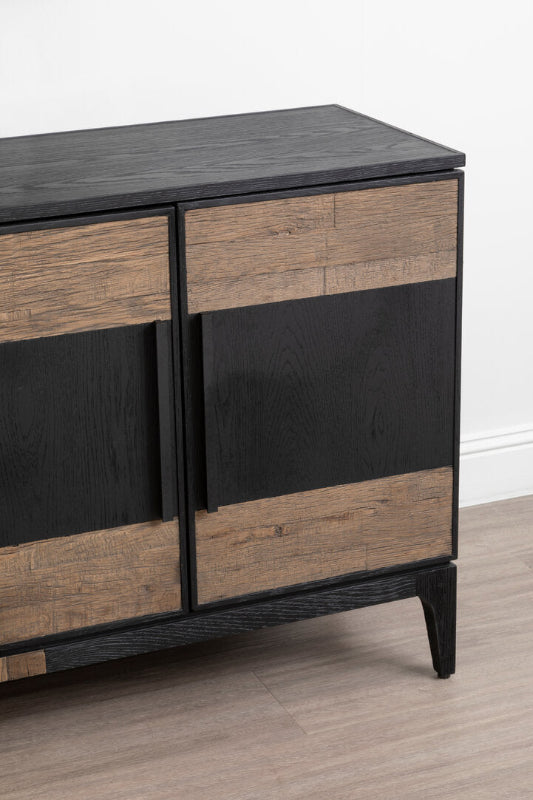 Wooden sideboard with black and natural wood panels on a light wooden floor.