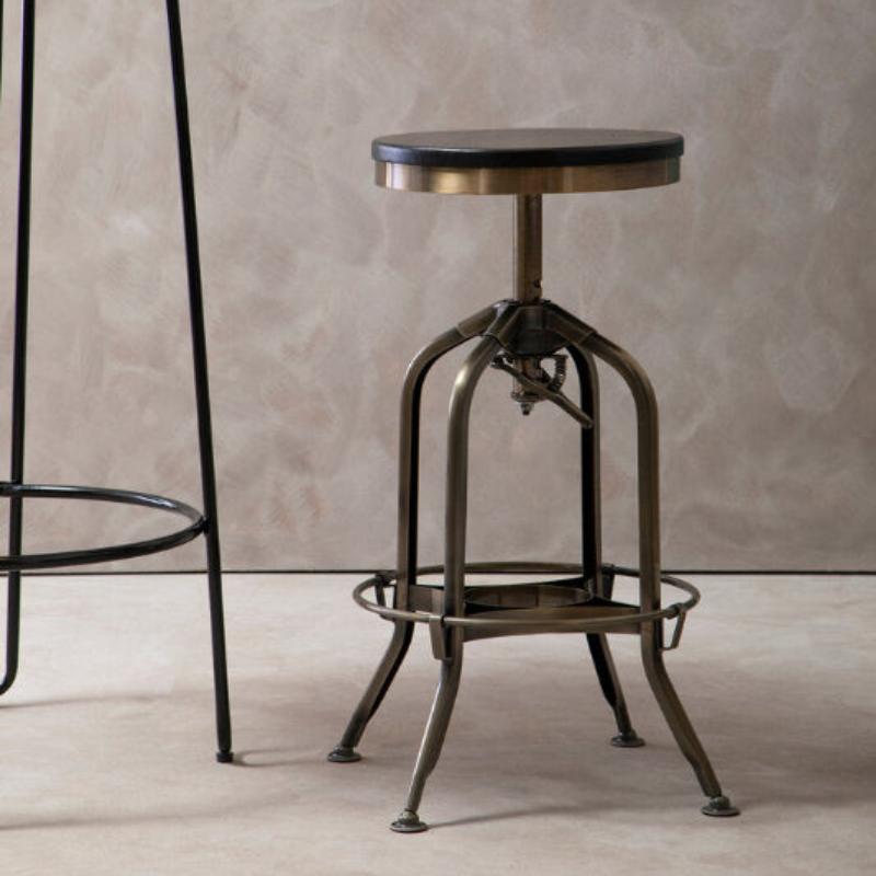 Vintage-style adjustable bar stool against a neutral wall.