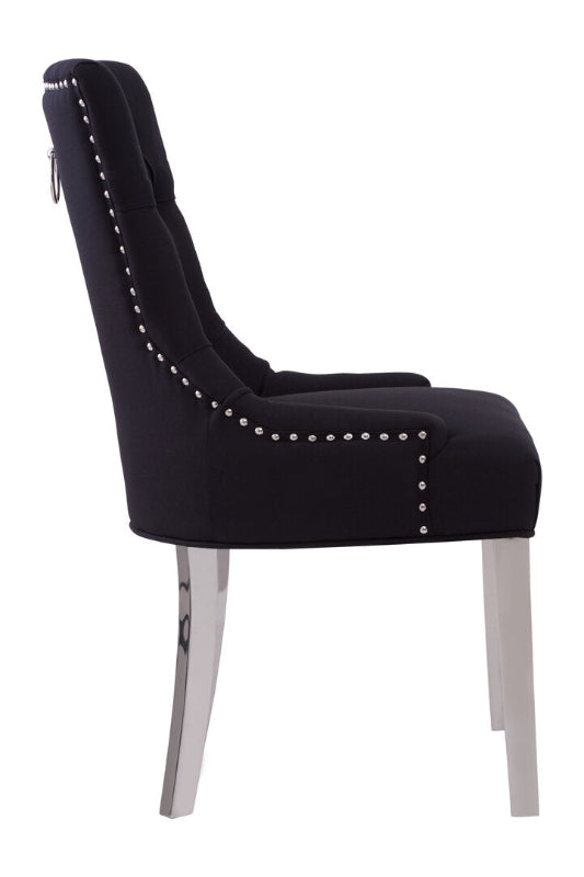 Black upholstered chair with silver nailhead trim on a white background