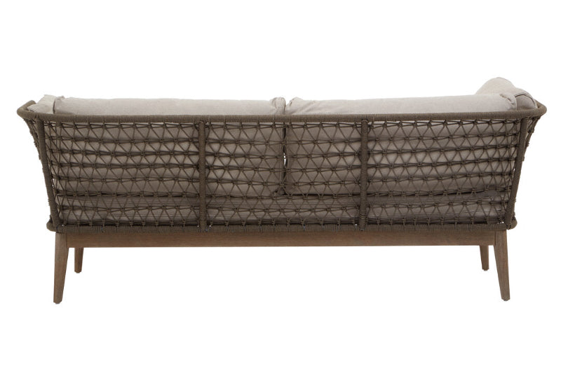 Wicker outdoor sofa with beige cushions on a white background
