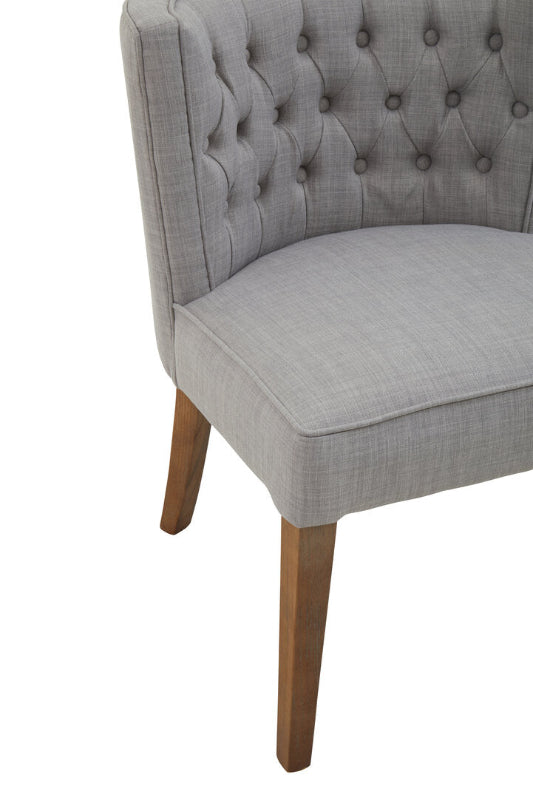 Gray upholstered chair with wooden legs on a white background