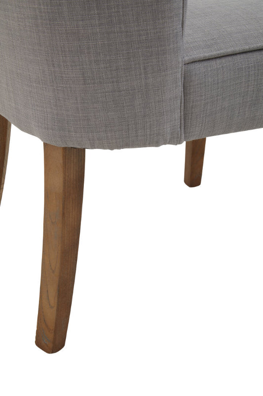 Gray upholstered chair with wooden legs on a white background