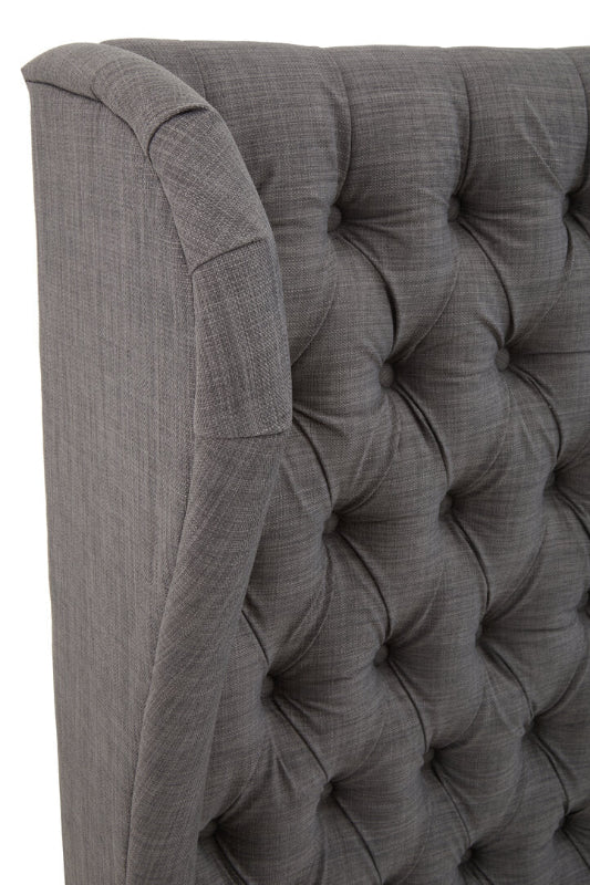 Gray tufted headboard with a textured finish