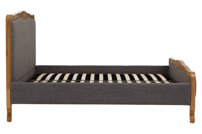 Gray upholstered bed with wooden frame and slats on a white background