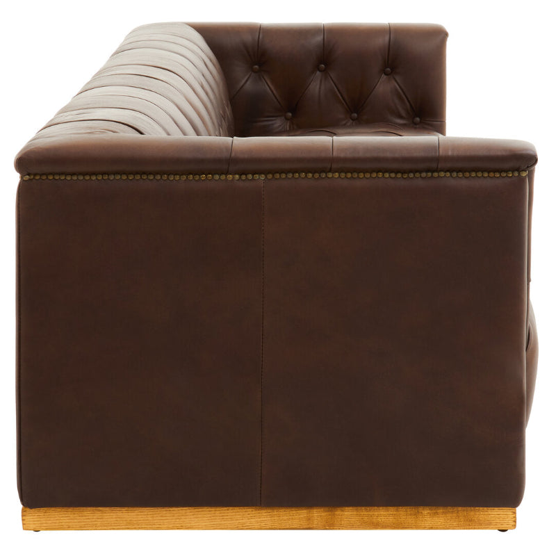 Brown leather sofa with tufted backrest on a white background