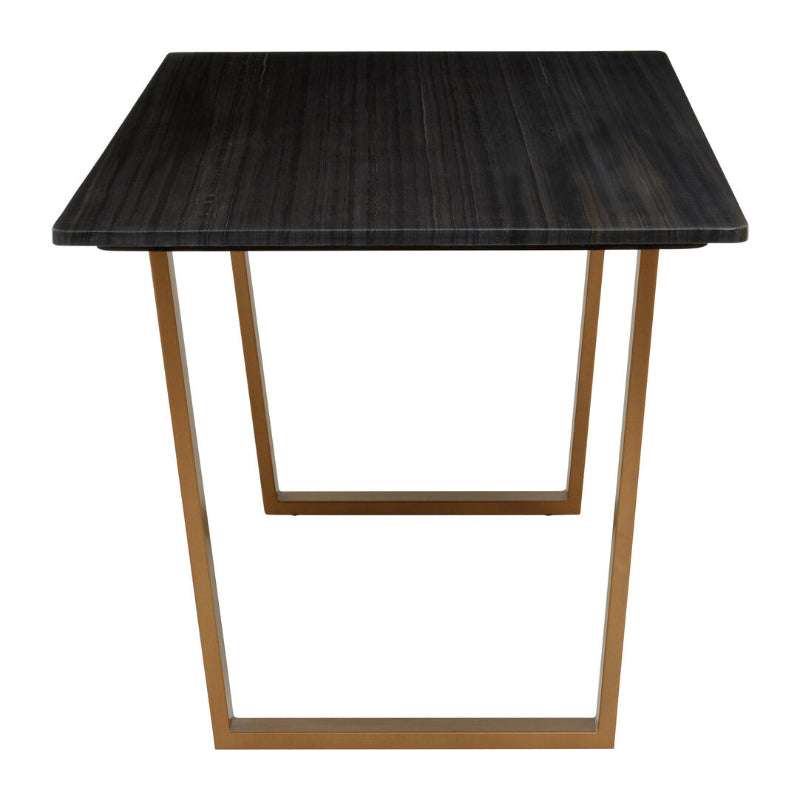 Dining table with black marble top and gold metal legs on a white background