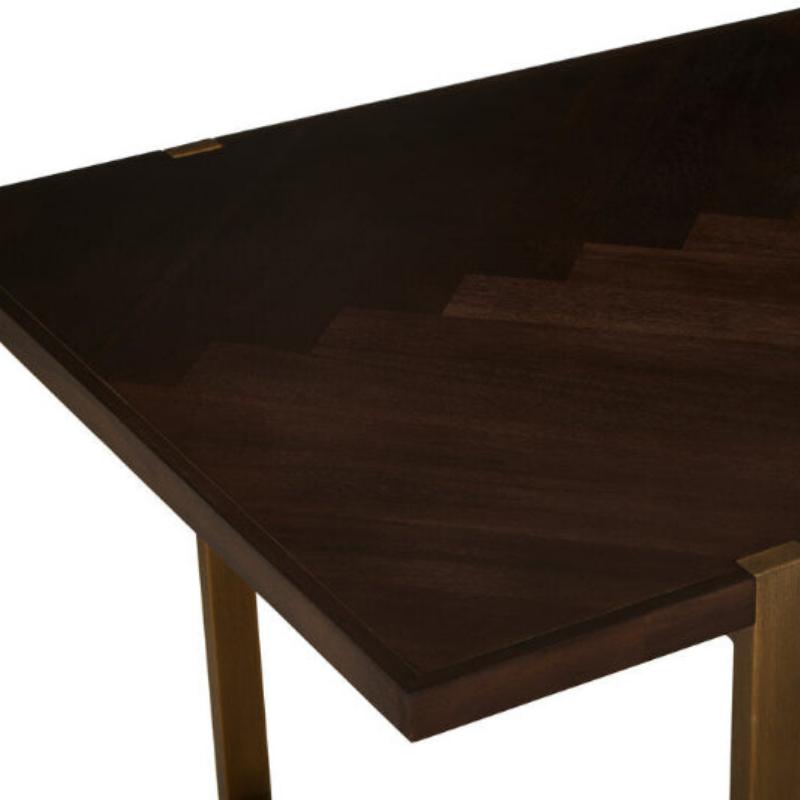 Dark wooden table top and brass legs on a white background