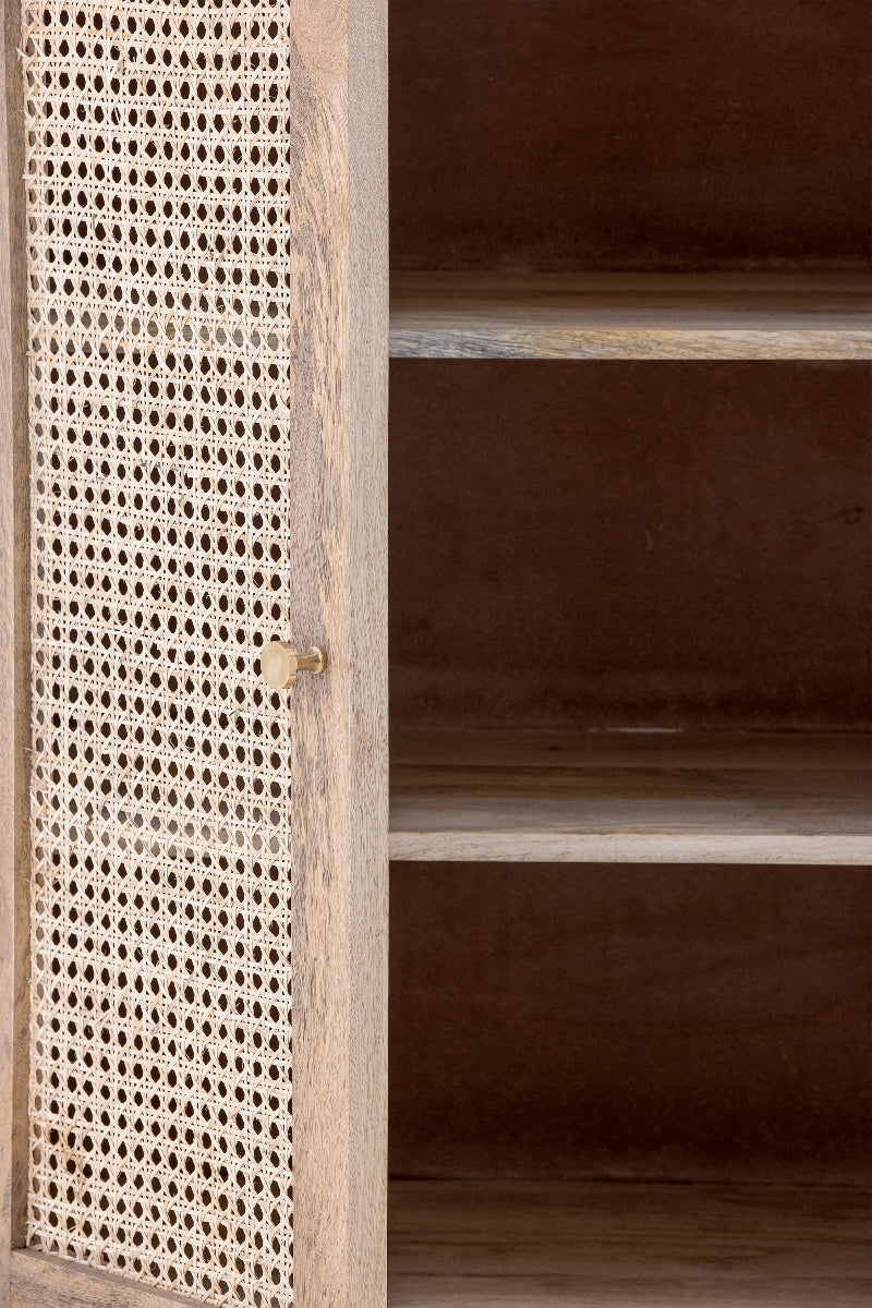 Wooden cabinet with rattan door panel on a dark background