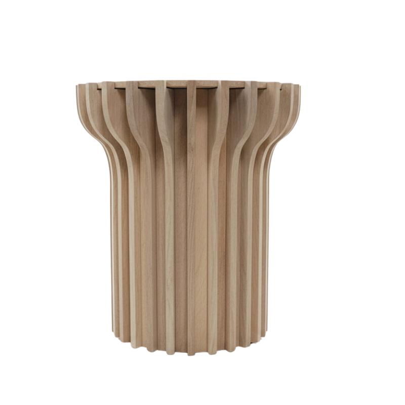 A modern wooden side table with a fluted, ribbed cylindrical design in a light natural wood finish, shown against a plain white background.