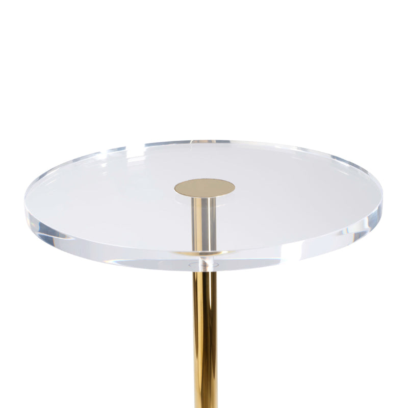 Round glass table with a gold metal base on a white background