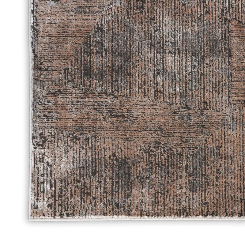 Textured area rug with brown and beige pattern on a white background