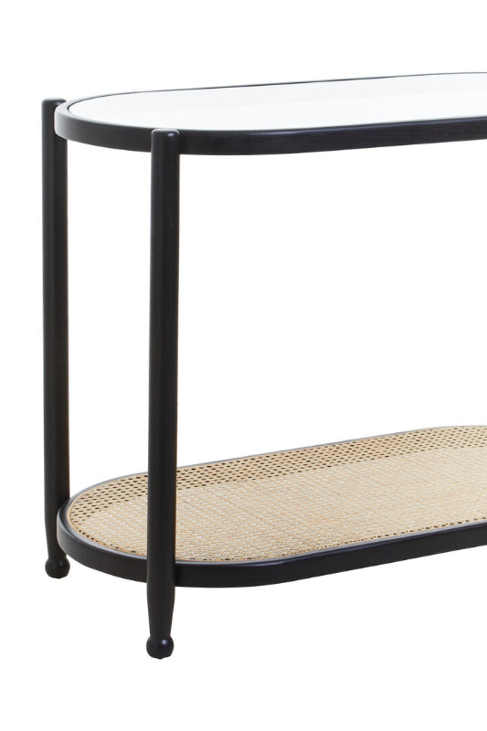 Console table with black metal frame and woven shelf on a white background
