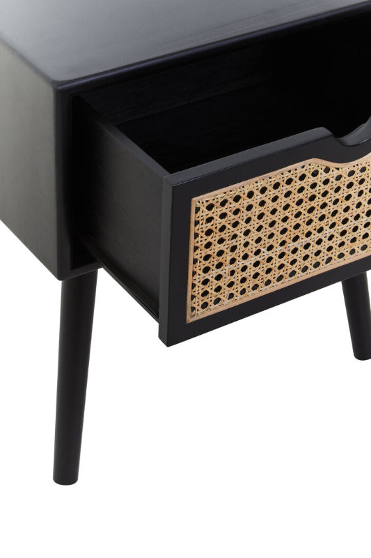 Black side table with a woven drawer handle on a white background