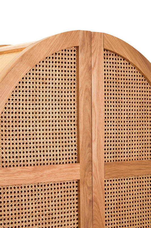 Wooden cabinet with woven cane design on a white background