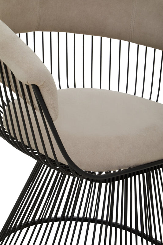 Beige cushioned chair with black metal frame on a white background