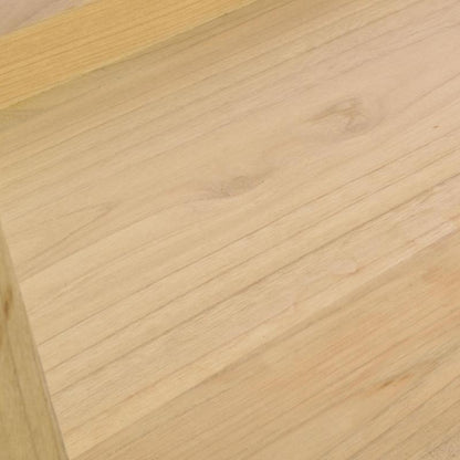 Close-up of a light natural wood surface with visible grain and a slightly darker wood edge at the top left.