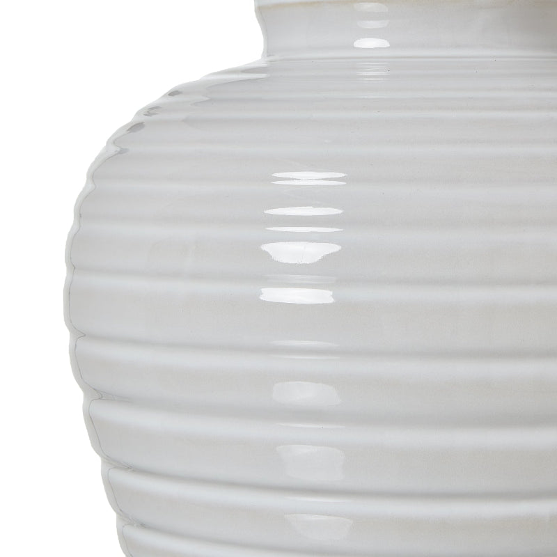 Close-up of a white ribbed vase on a white background
