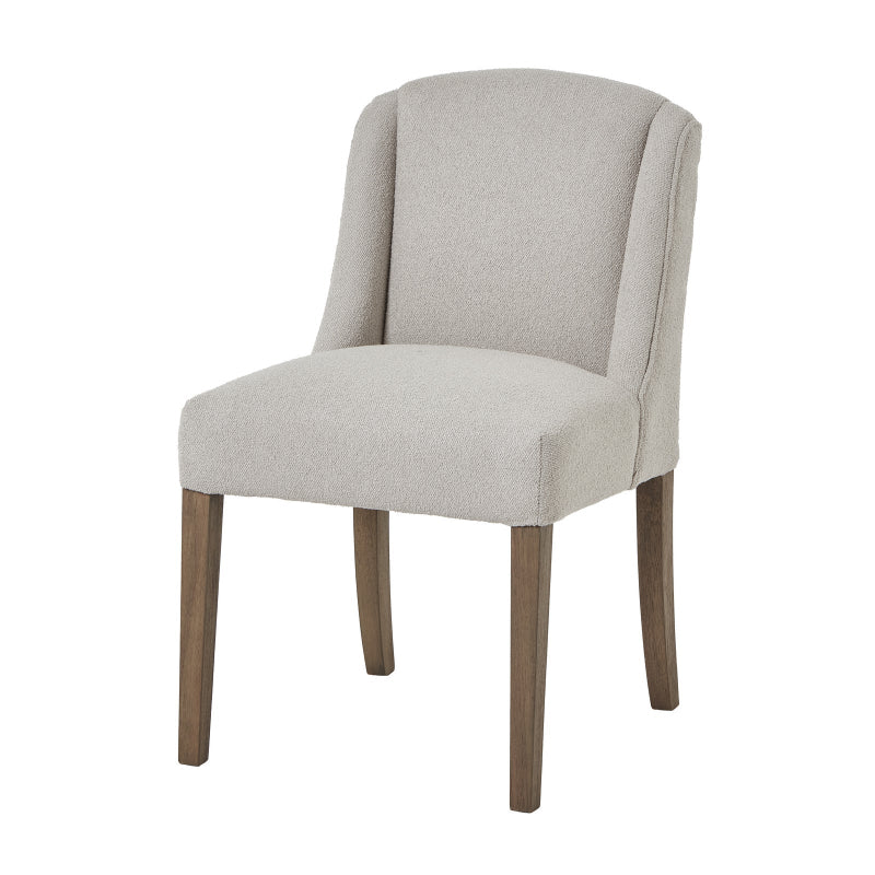 Neutral upholstered chair with wooden legs on a white background