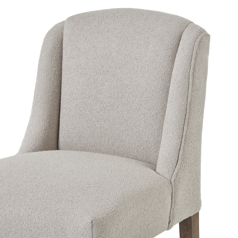 Neutral upholstered chair on a white background