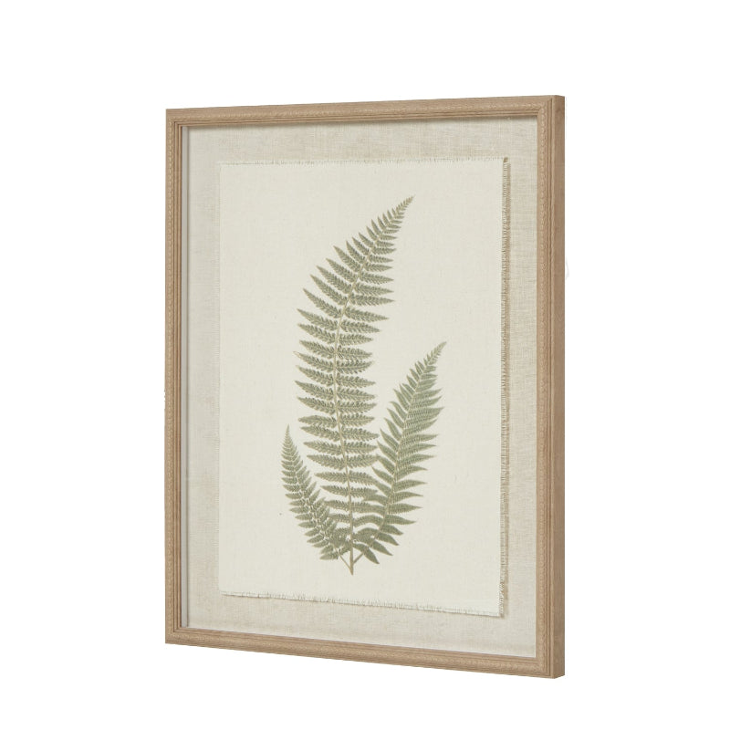 Framed artwork with a green fern leaf design on a beige background