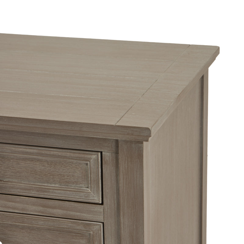 Close-up of a wooden dresser with a light grey finish on a white background