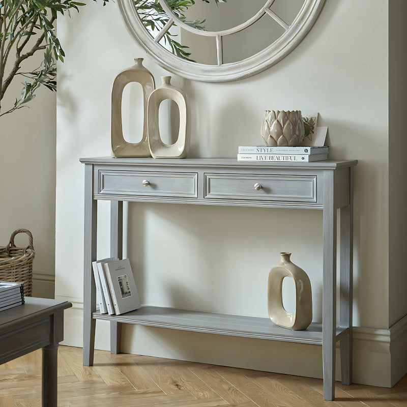 Grey console table with decorative items in a room setting