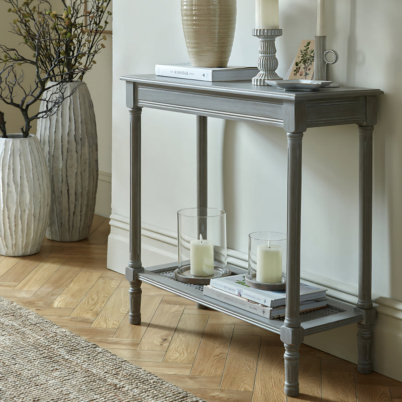 Grey console table with decorative items in a room setting