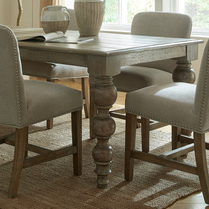 Dining room with a wooden table and chairs in a well-lit room.