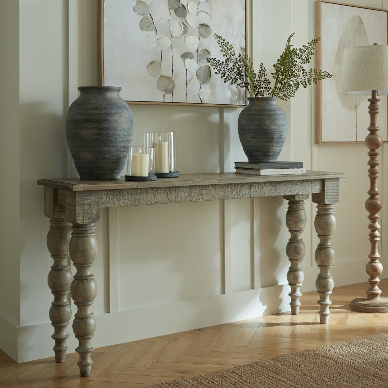 Wooden console table with decorative items in a room setting