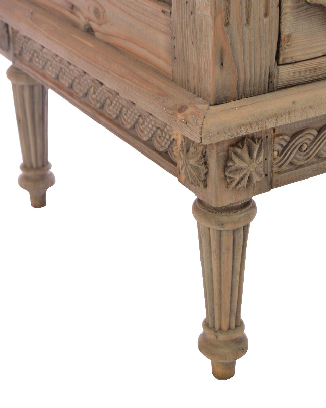 Wooden side table with intricate carvings on a white background