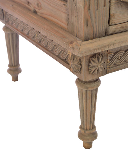 Wooden side table with intricate carvings on a white background