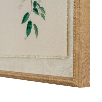 Framed artwork with green leaves on a beige background