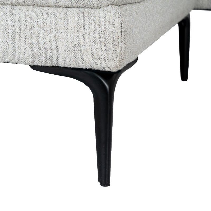 Close-up of a gray upholstered chair with black legs on a white background