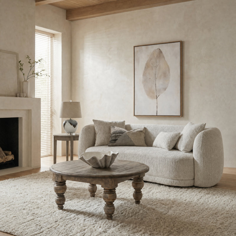 Living room with a beige sofa, wooden coffee table, and abstract art on the wall.