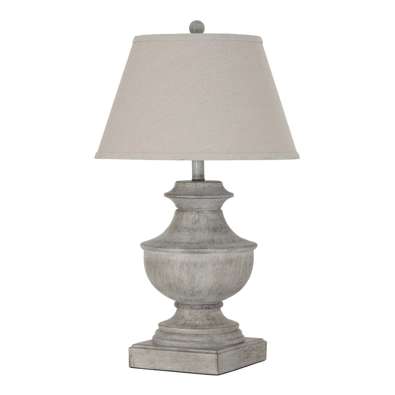 Table lamp with a textured gray base and beige lampshade on a white background