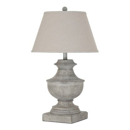 Table lamp with a textured gray base and beige lampshade on a white background