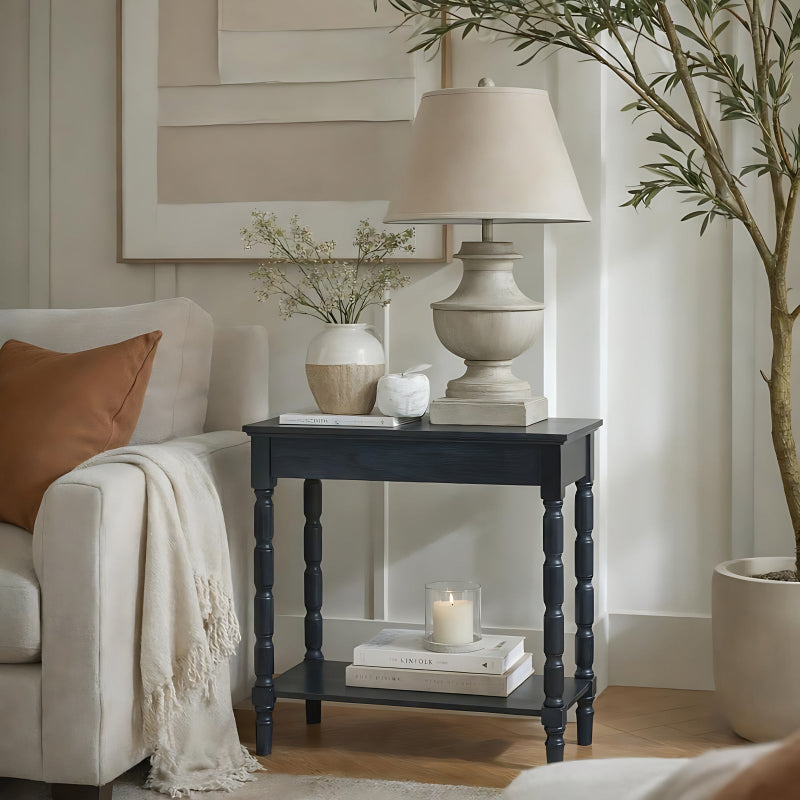 Living room with a side table, lamp, and decor items.