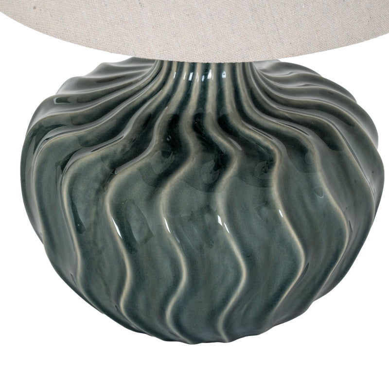 Decorative lamp base with wavy texture on a white background