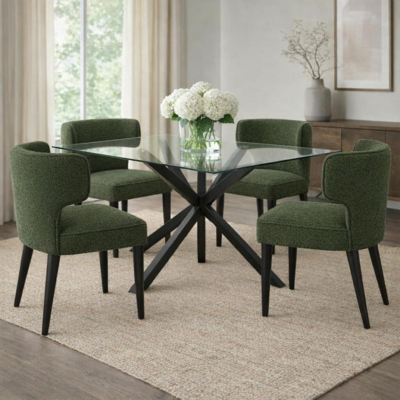 Dining room with a glass table and green chairs on a beige rug.