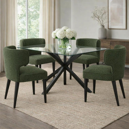 Dining room with a glass table and green chairs on a beige rug.