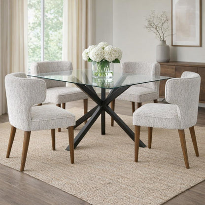 Dining room with a glass table and upholstered chairs on a beige rug.