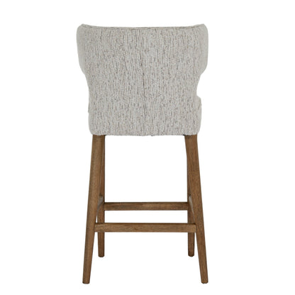 Bar stool with gray cushioned seat and wooden legs on a white background