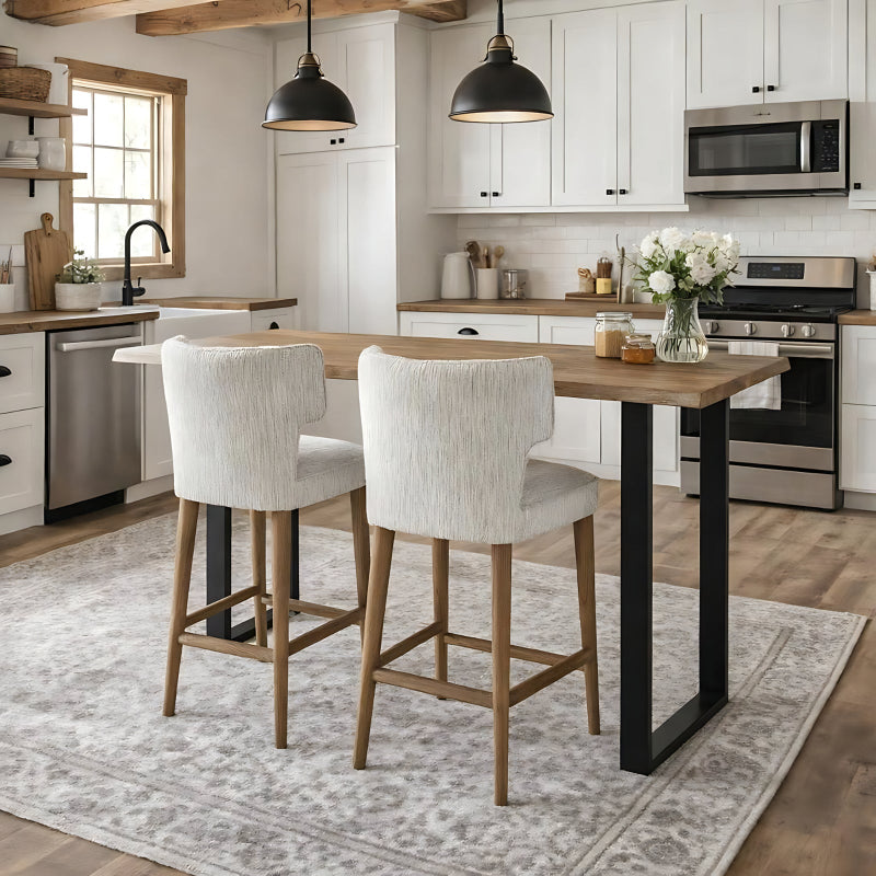 Modern kitchen with a wooden dining table and chairs, stainless steel appliances, and white cabinets.