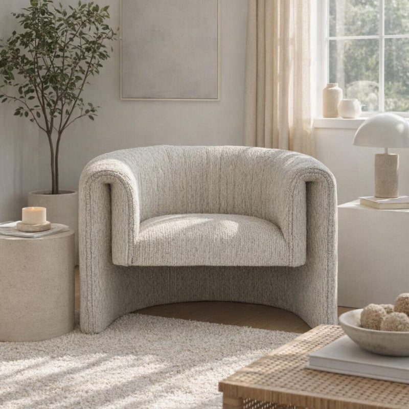 Beige armchair in a living room setting with decor elements.