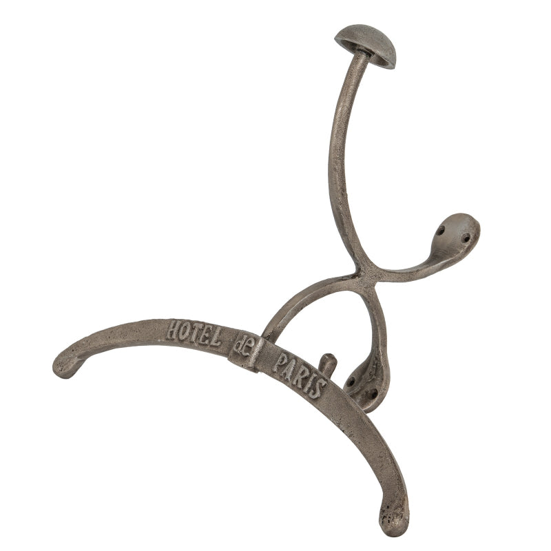 Decorative metal hook with 'Hotel de Paris' engraving on a white background