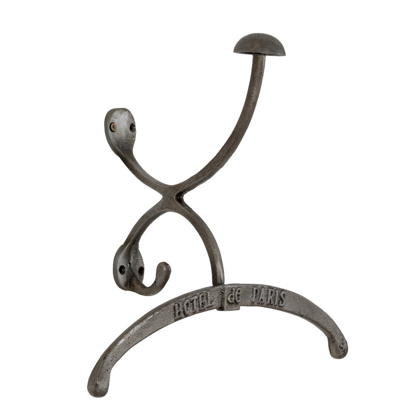 Decorative metal hook with 'Hotel de Paris' inscription on a white background